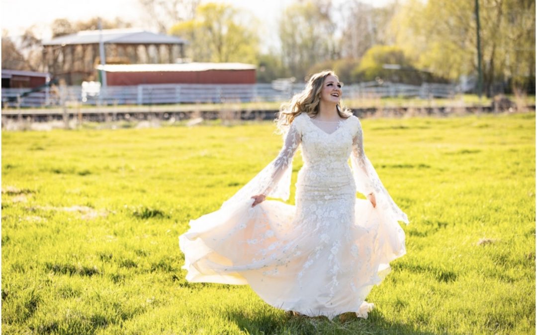 a woman in a wedding dress running through a field
