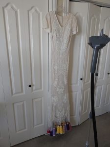 a wedding dress with spools of colored thread