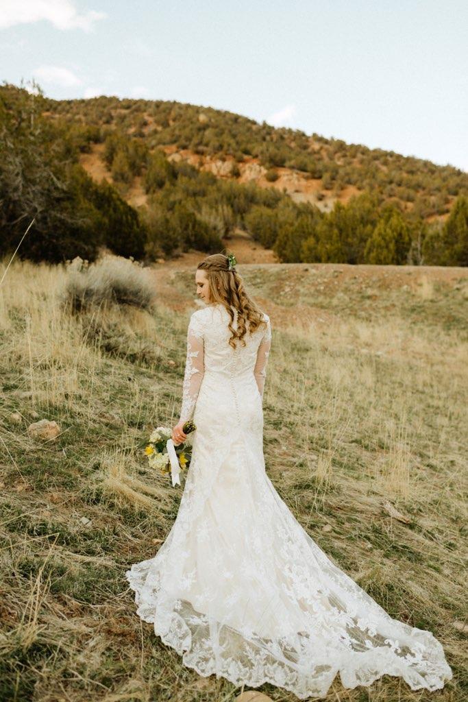 a beautiful bride walking towards a mountain