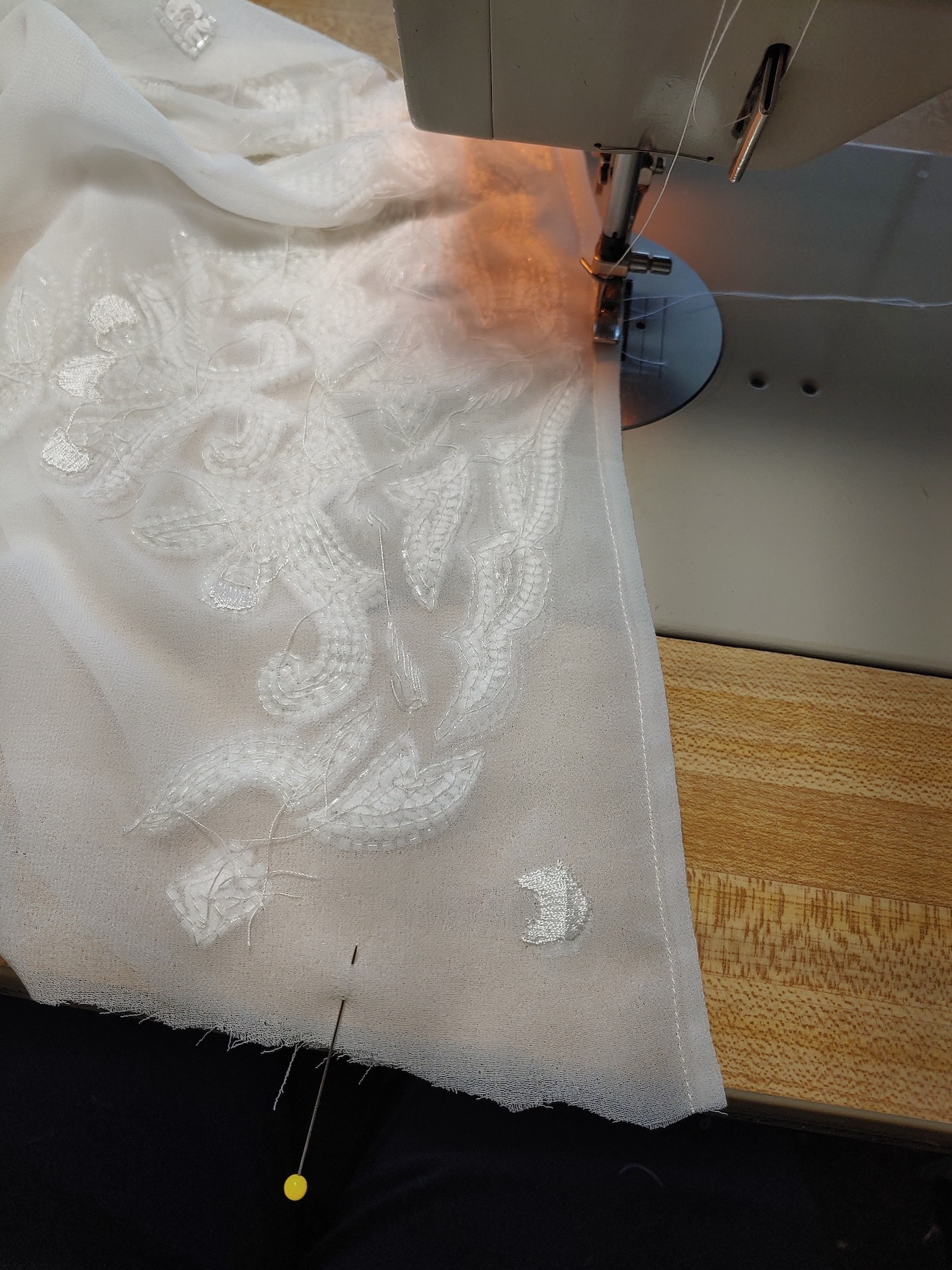 Sewing the hem of a wedding dress
