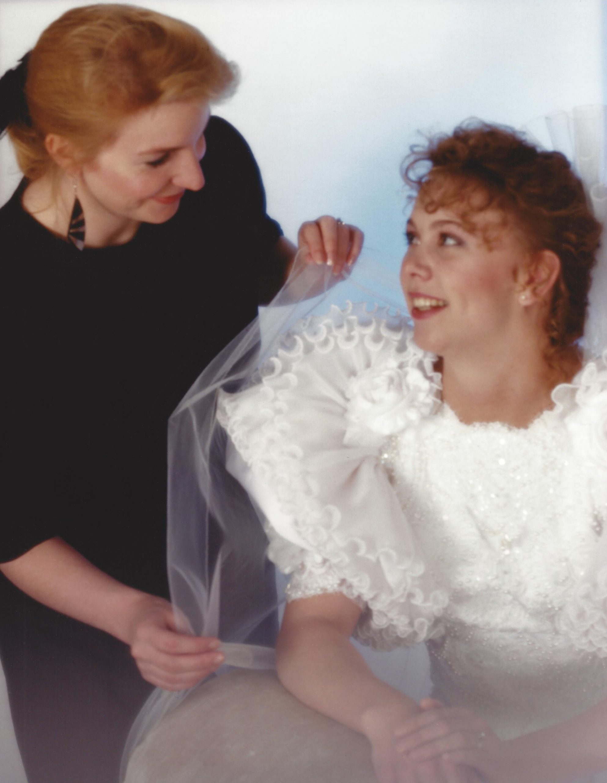 A photo of DeeDee doing alteration for brides and their dresses