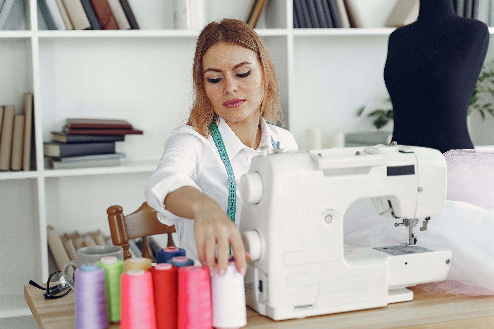 dressmaker-in-front-of-her-sewing-machine-3984844