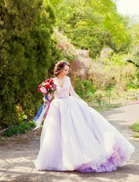 a woman in a white and purple wedding dress with flowers