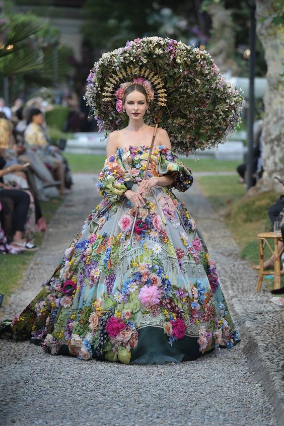 a woman in a flowery dress with a flowery parasol