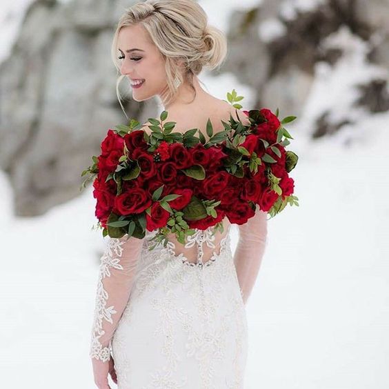 a woman in a dress with roses on her shoulders