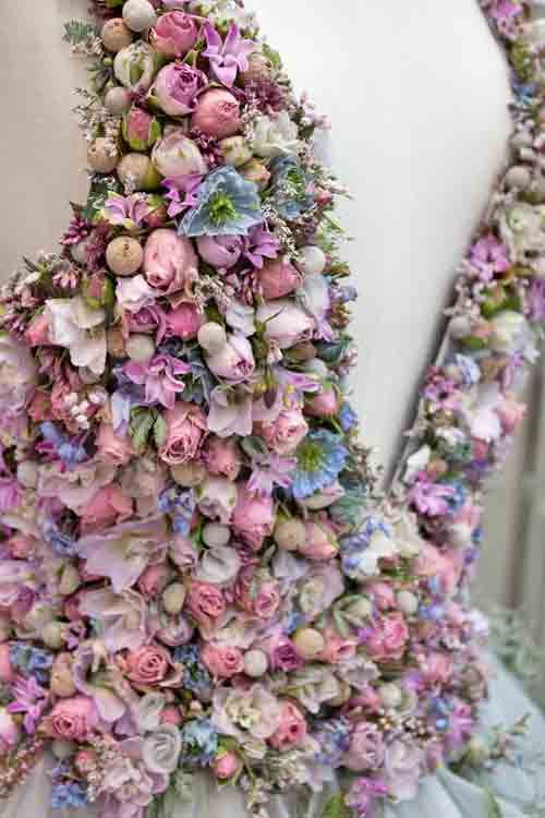 a wedding dress made mostly out of flowers