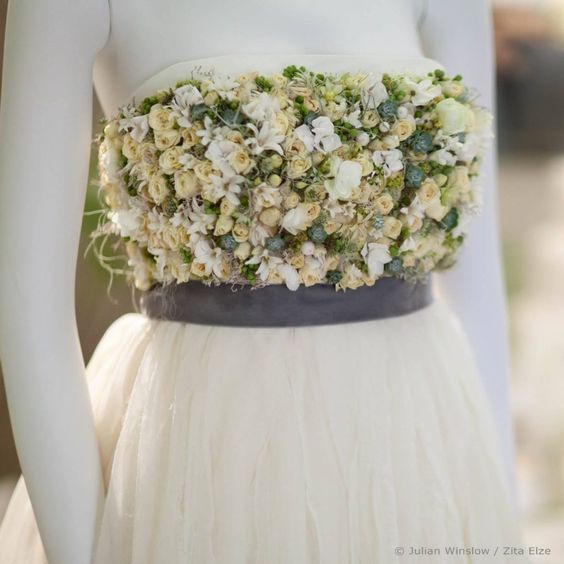 a white wedding dress with flowers
