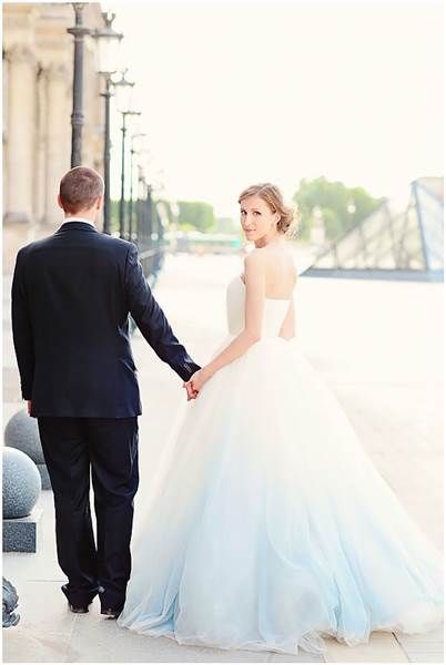 two people dressed for a wedding holding hands